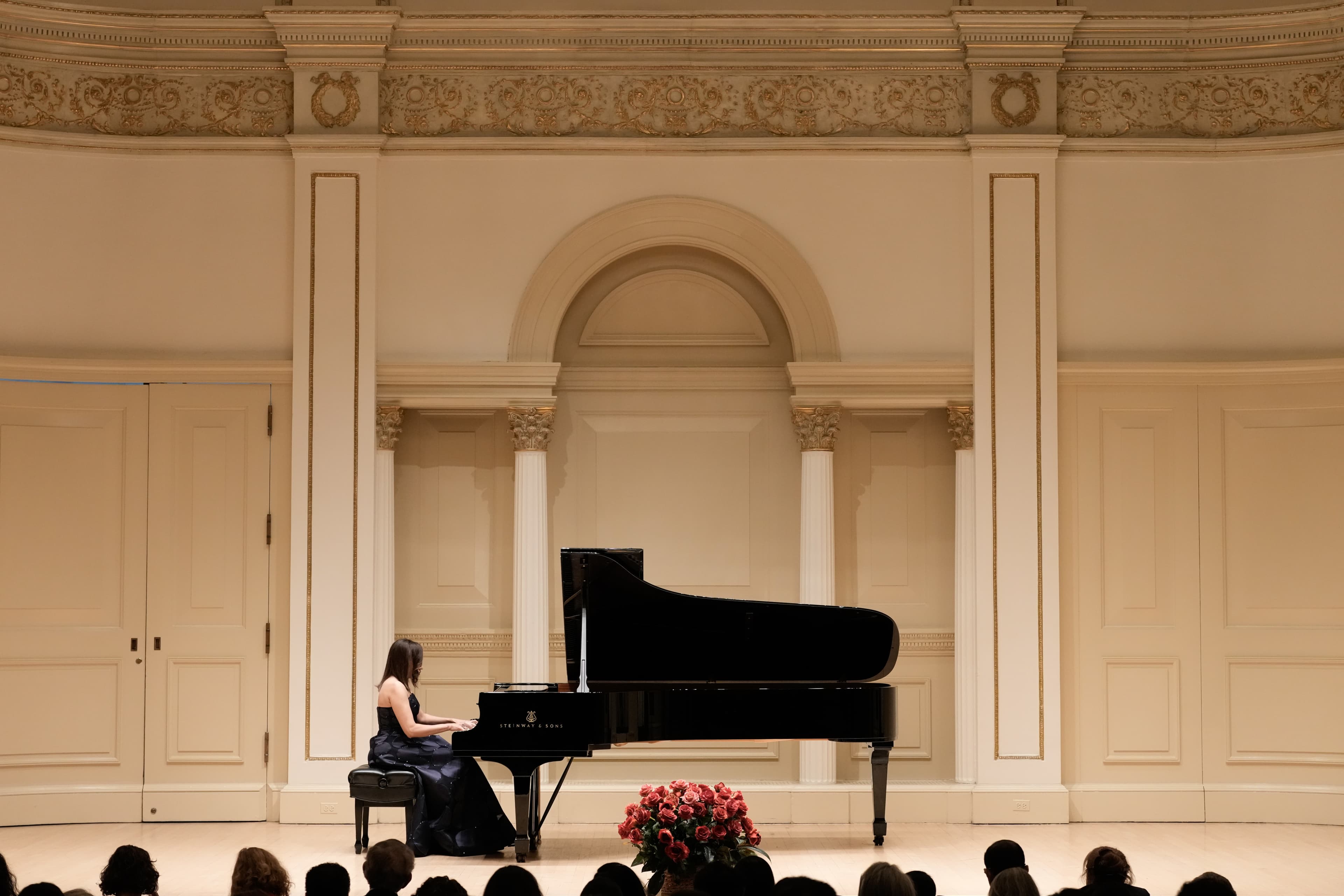 Nina Kidd sitting at the piano playing
